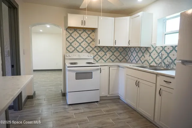 a kitchen with a refrigerator a stove a microwave and cabinets