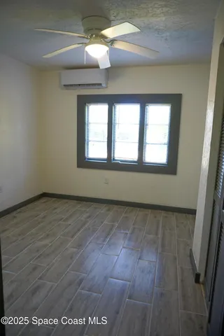 an empty room with wooden floor and closet