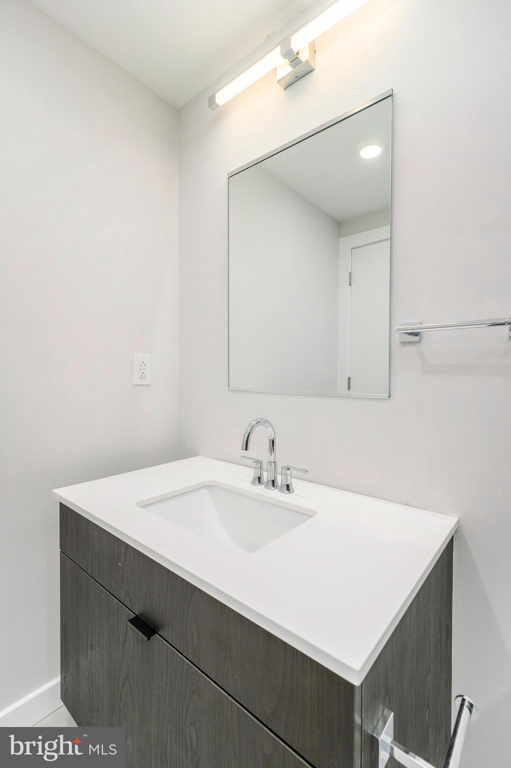 3449 Scotts Lane, Unit B221 Philadelphia, PA 19129 - Photo 20 of 21 a bathroom with a sink vanity and a mirror