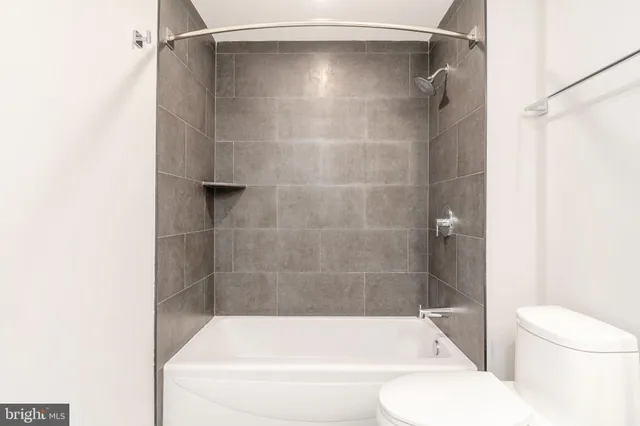 a bathroom with a shower and a toilet