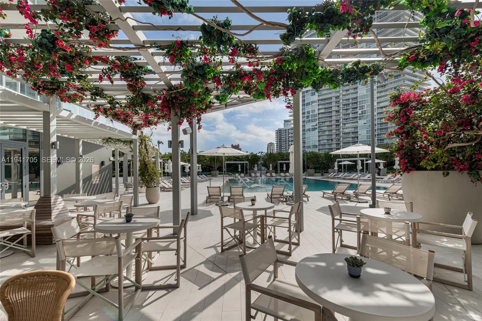 500 Alton Road, Unit 1204 Miami Beach, FL 33139 - Photo 16 of 22 a view of a patio with couches table and chairs and potted plants