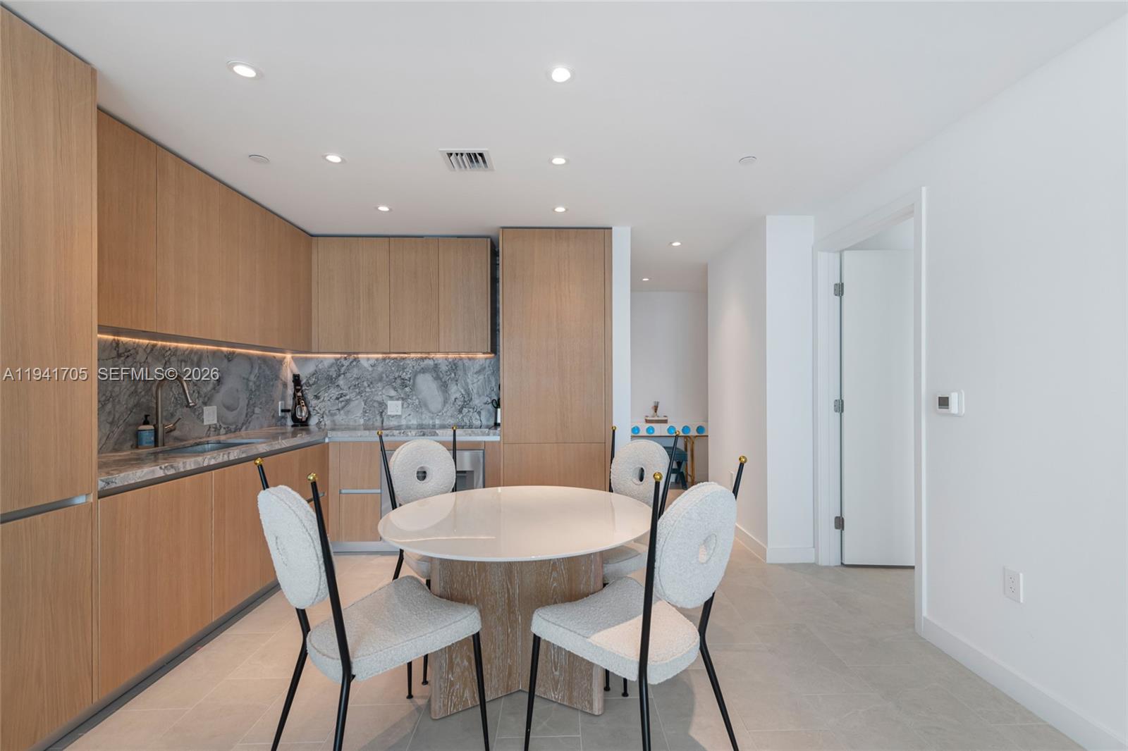 500 Alton Road, Unit 1204 Miami Beach, FL 33139 - Photo 2 of 22 a view of a dining room with furniture and wooden floor