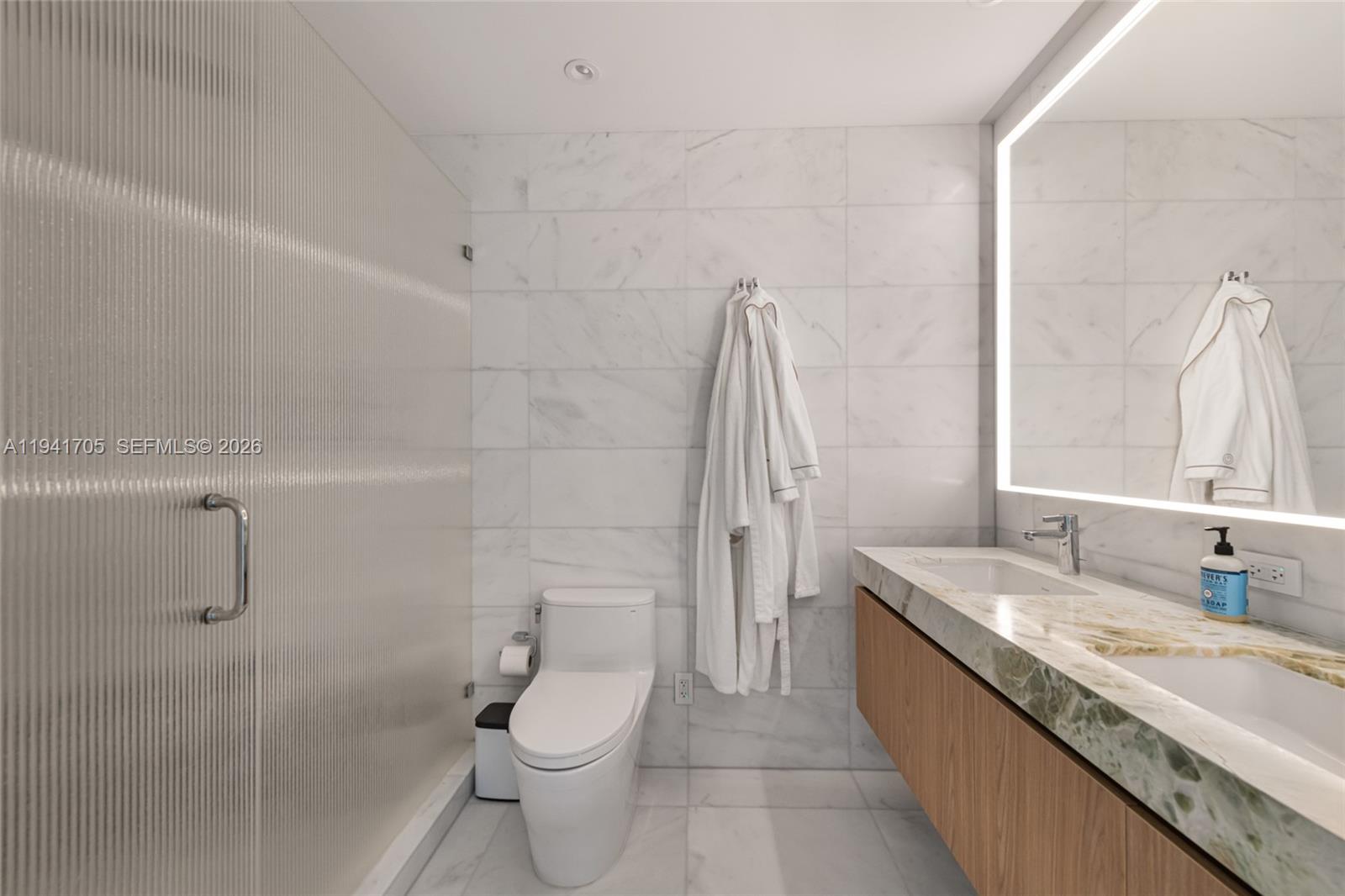 500 Alton Road, Unit 1204 Miami Beach, FL 33139 - Photo 7 of 22 a bathroom with a granite countertop sink a toilet and shower
