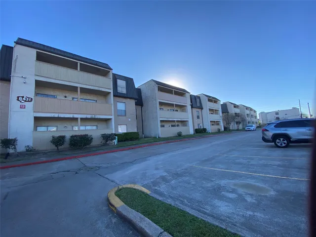 a view of a car park in front of a building