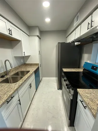 a kitchen that has a sink and a stove