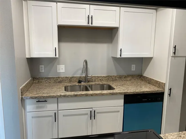 a kitchen with a sink and cabinets