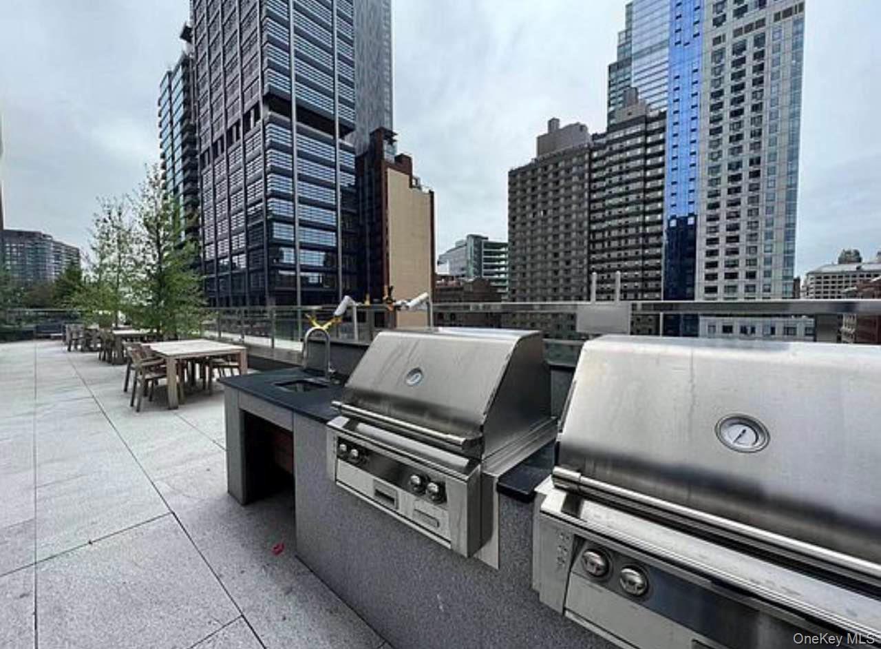 131-03 40 Road, Unit 18E Queens, NY 11354 - Photo 17 of 33 a view of barbeque area with outdoor seating