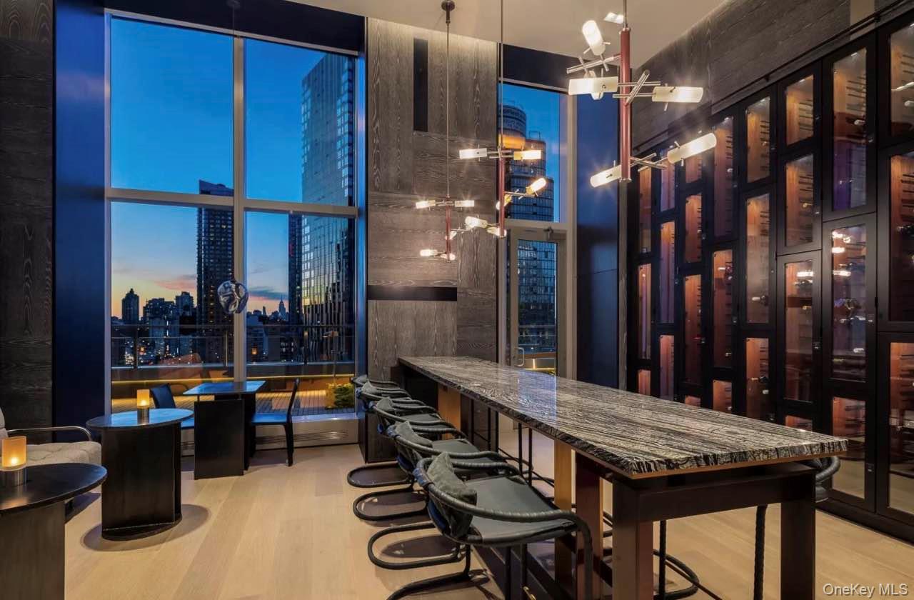 131-03 40 Road, Unit 18E Queens, NY 11354 - Photo 28 of 33 a dining room with furniture and wooden floor