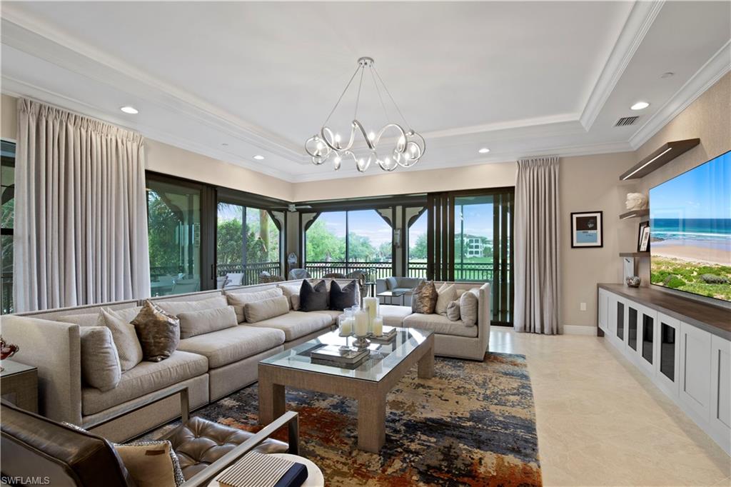 16391 Viansa Way, Unit 101 Naples, FL 34110 - Photo 11 of 48 a living room with furniture and a large window