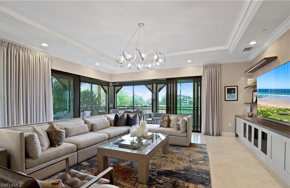 16391 Viansa Way, Unit 101 Naples, FL 34110 - Photo 12 of 48 a living room with furniture and a large window