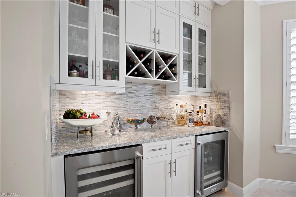 16391 Viansa Way, Unit 101 Naples, FL 34110 - Photo 20 of 48 a kitchen with a sink and cabinets
