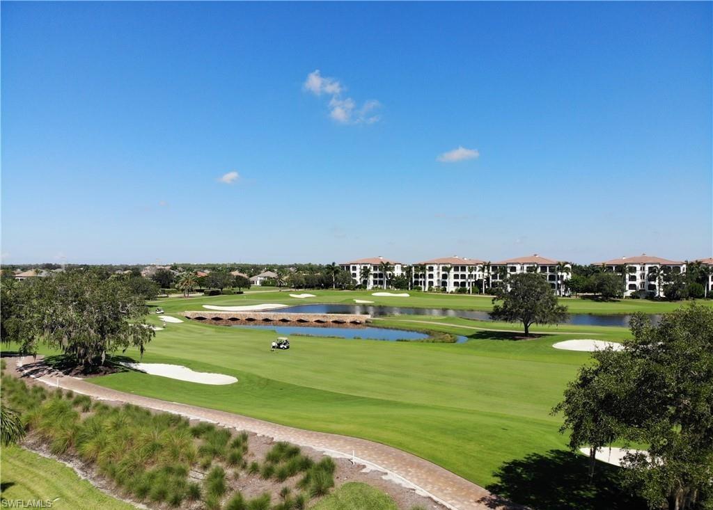 16391 Viansa Way, Unit 101 Naples, FL 34110 - Photo 23 of 48 a view of a lake with a building in the background