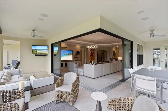 a view of a balcony with furniture and a floor to ceiling window