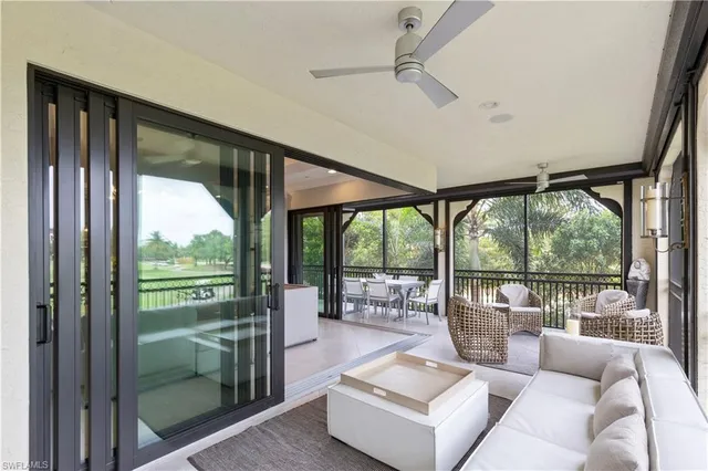 a view of a porch with furniture and floor to ceiling window