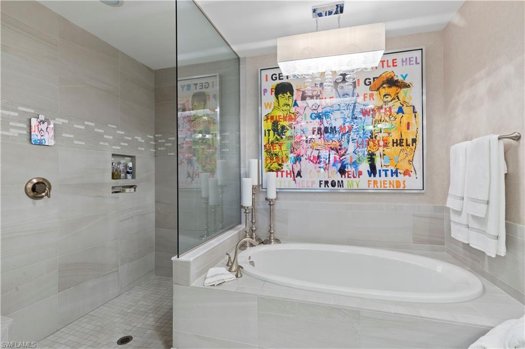 16391 Viansa Way, Unit 101 Naples, FL 34110 - Photo 33 of 48 a bathroom with a bathtub and a shower