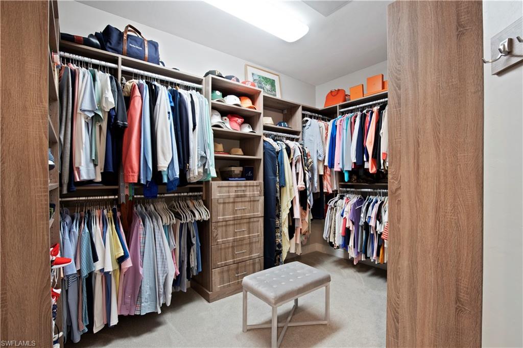 16391 Viansa Way, Unit 101 Naples, FL 34110 - Photo 34 of 48 a view of walk in closet with clothes and shoes