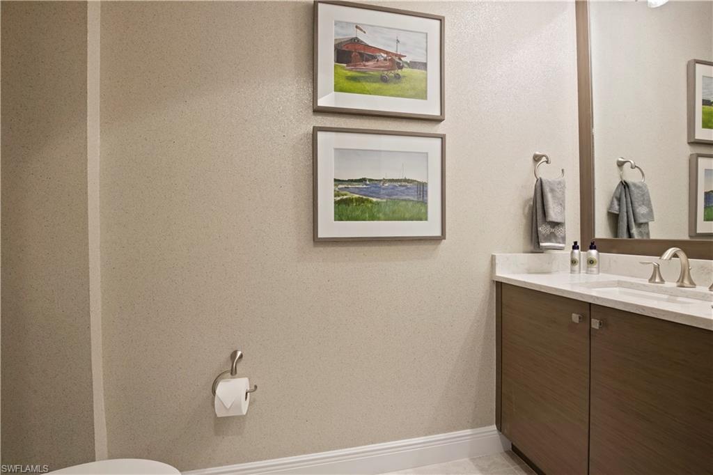 16391 Viansa Way, Unit 101 Naples, FL 34110 - Photo 35 of 48 a bathroom with a sink and a mirror