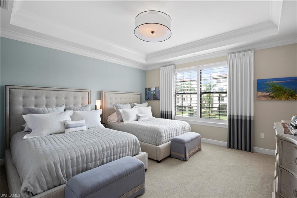 16391 Viansa Way, Unit 101 Naples, FL 34110 - Photo 37 of 48 a bedroom with bed and a large window