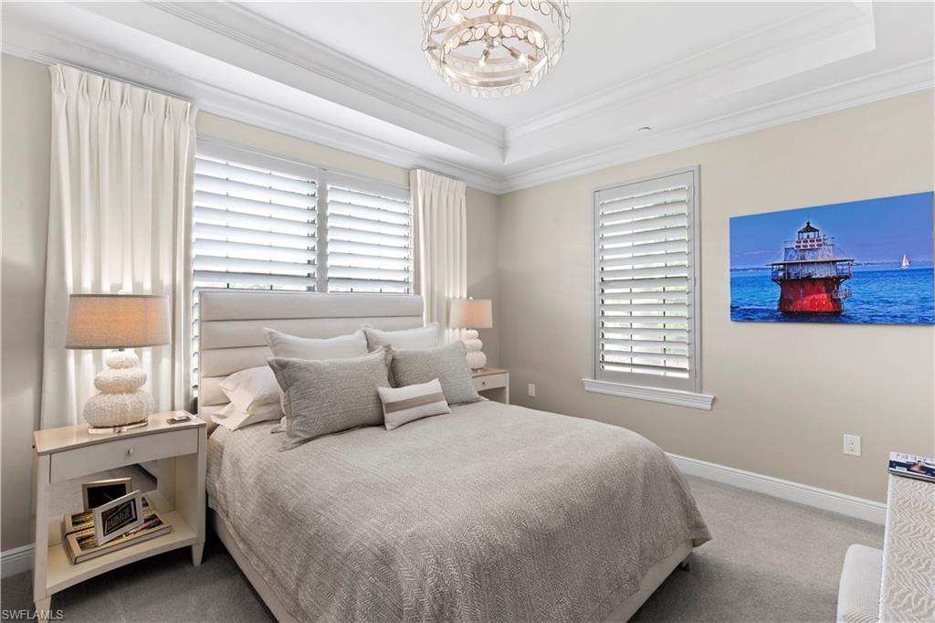 16391 Viansa Way, Unit 101 Naples, FL 34110 - Photo 39 of 48 a bedroom with a bed and a window