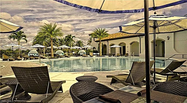 an aerial view of a house with a garden and lake view