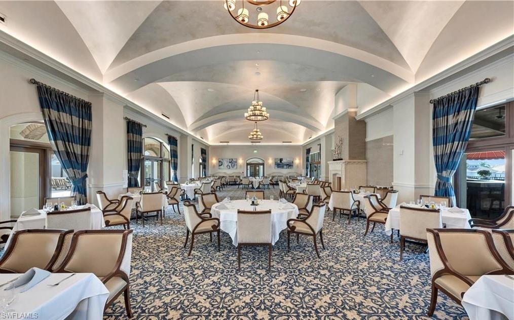 16391 Viansa Way, Unit 101 Naples, FL 34110 - Photo 45 of 48 a living room with lots of furniture and a chandelier