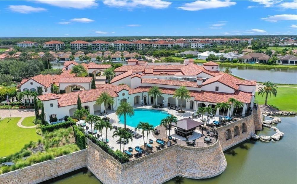 16391 Viansa Way, Unit 101 Naples, FL 34110 - Photo 47 of 48 an aerial view of a house with a garden and lake view
