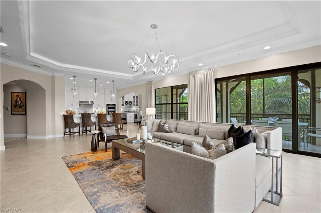 16391 Viansa Way, Unit 101 Naples, FL 34110 - Photo 10 of 48 a living room with furniture and a large window