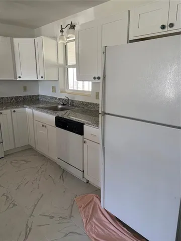 a kitchen with a refrigerator and a sink