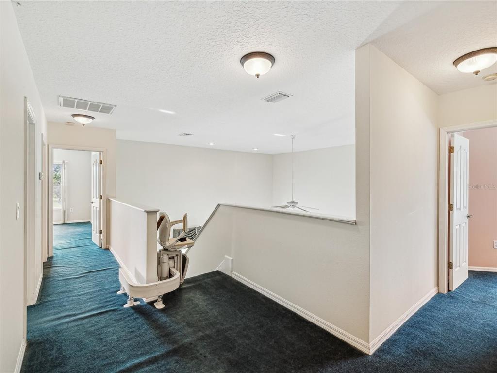 15420 Aubrey Avenue Spring Hill, FL 34610 - Photo 16 of 28 a view of an empty room with wooden floor