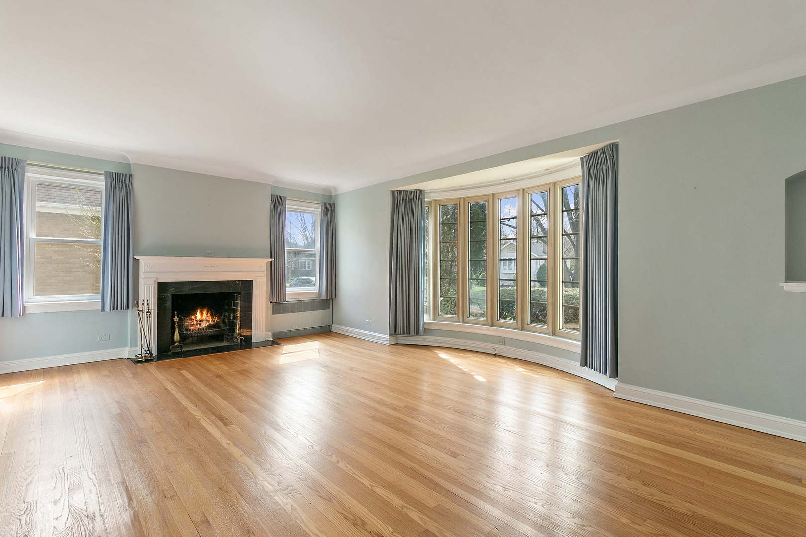 294 Shenstone Road Riverside, IL 60546 - Photo 3 of 29 a view of an empty room with wooden floor fireplace and a window