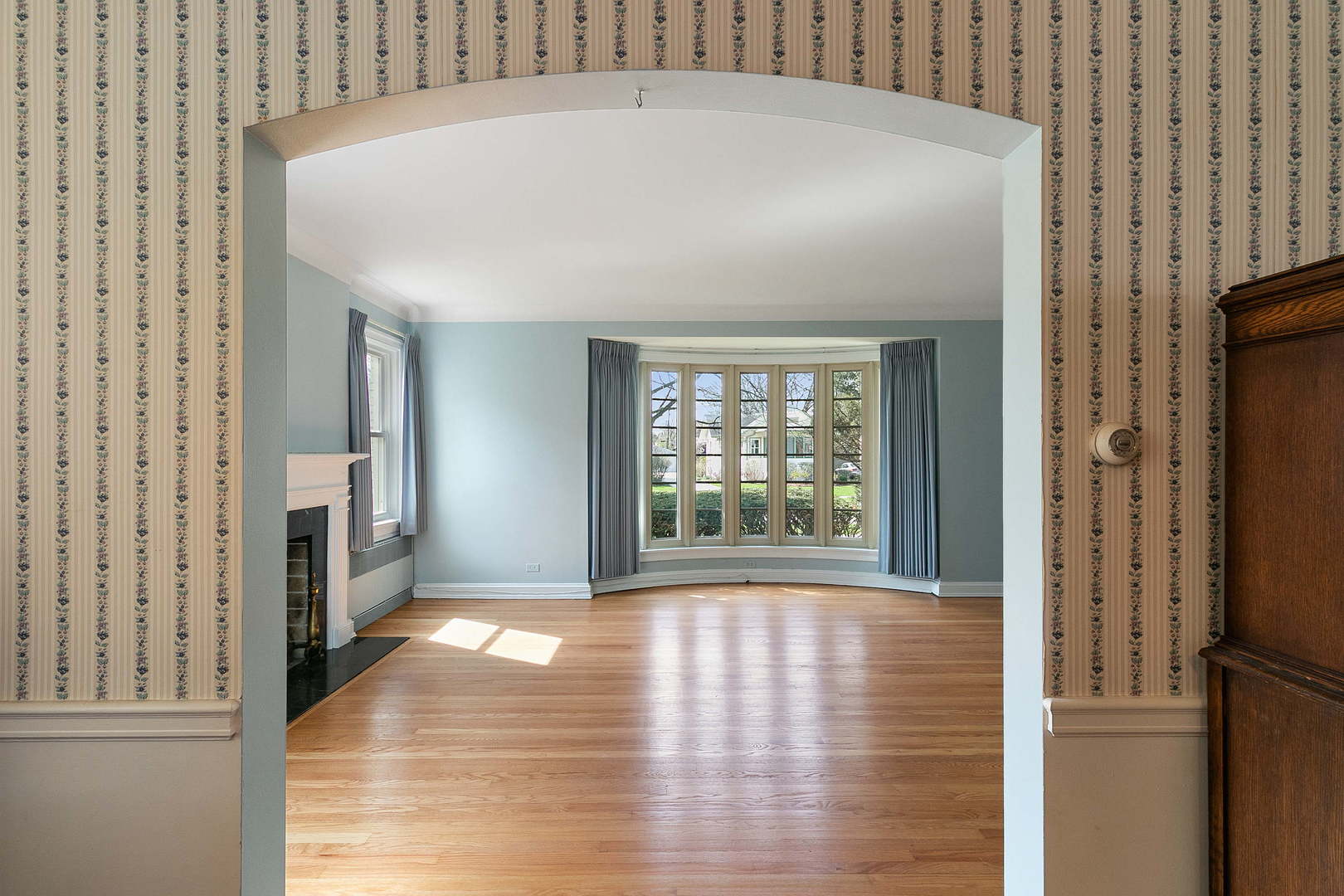 294 Shenstone Road Riverside, IL 60546 - Photo 6 of 29 a view of an empty room with wooden floor and a window
