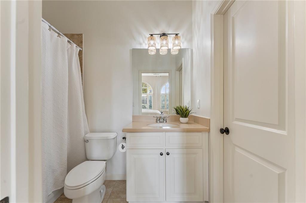 1950 Heritage Walk Alpharetta, GA 30004 - Photo 12 of 64 a bathroom with a toilet a sink and a mirror