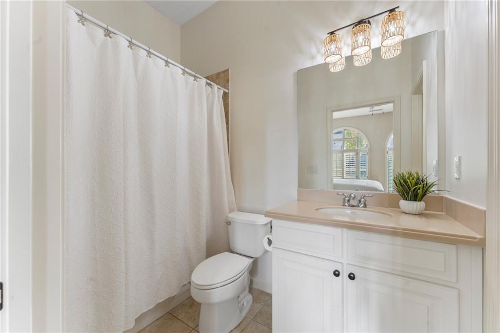 1950 Heritage Walk Alpharetta, GA 30004 - Photo 13 of 64 a bathroom with a sink a toilet and a mirror