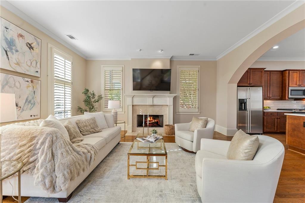 1950 Heritage Walk Alpharetta, GA 30004 - Photo 17 of 64 a living room with furniture a fireplace and a flat screen tv