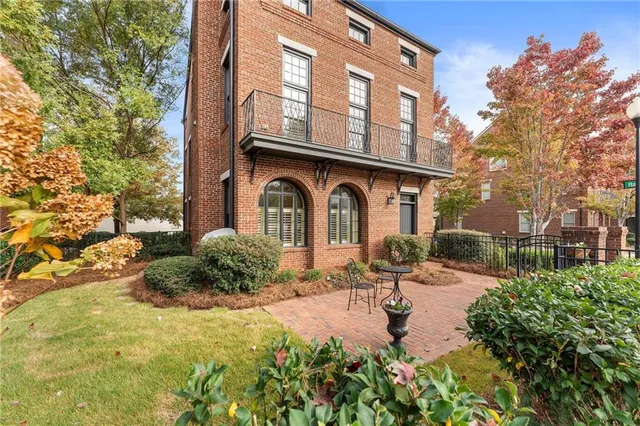 a view of house with yard and outdoor seating