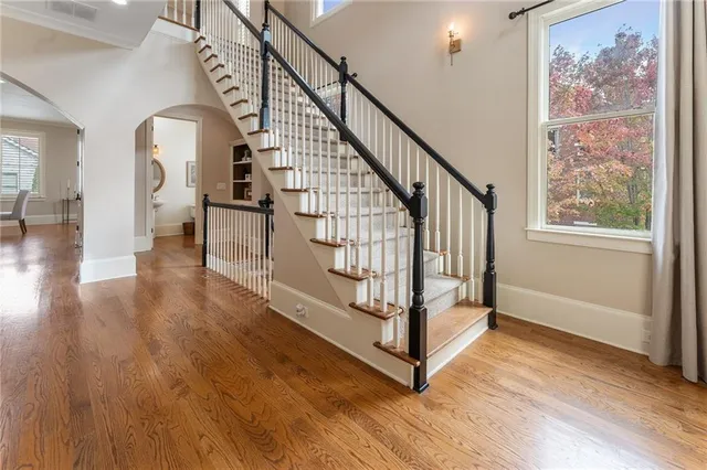 a spacious bathroom with a double vanity sink a large mirror and a bathtub