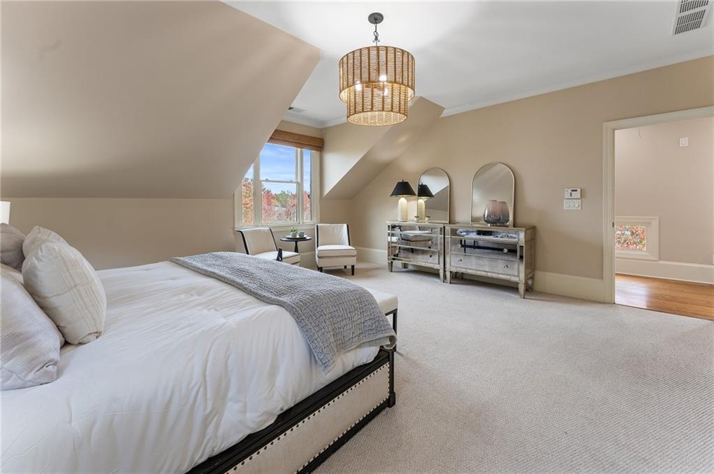 1950 Heritage Walk Alpharetta, GA 30004 - Photo 40 of 64 a bedroom with bed and a chandelier