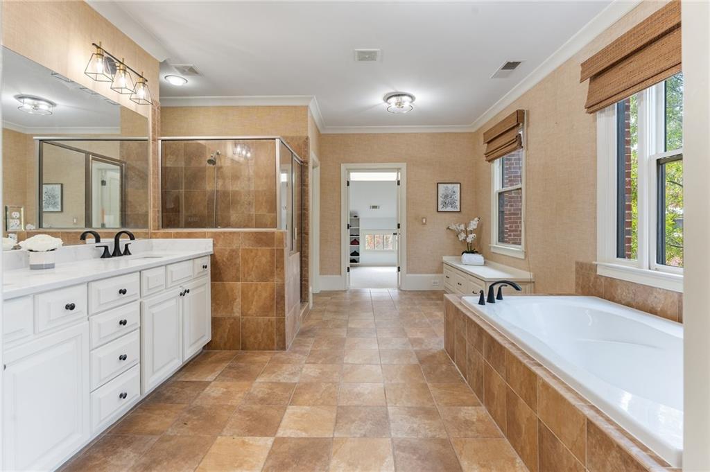 1950 Heritage Walk Alpharetta, GA 30004 - Photo 43 of 64 a spacious bathroom with a double vanity sink a large mirror and a bathtub