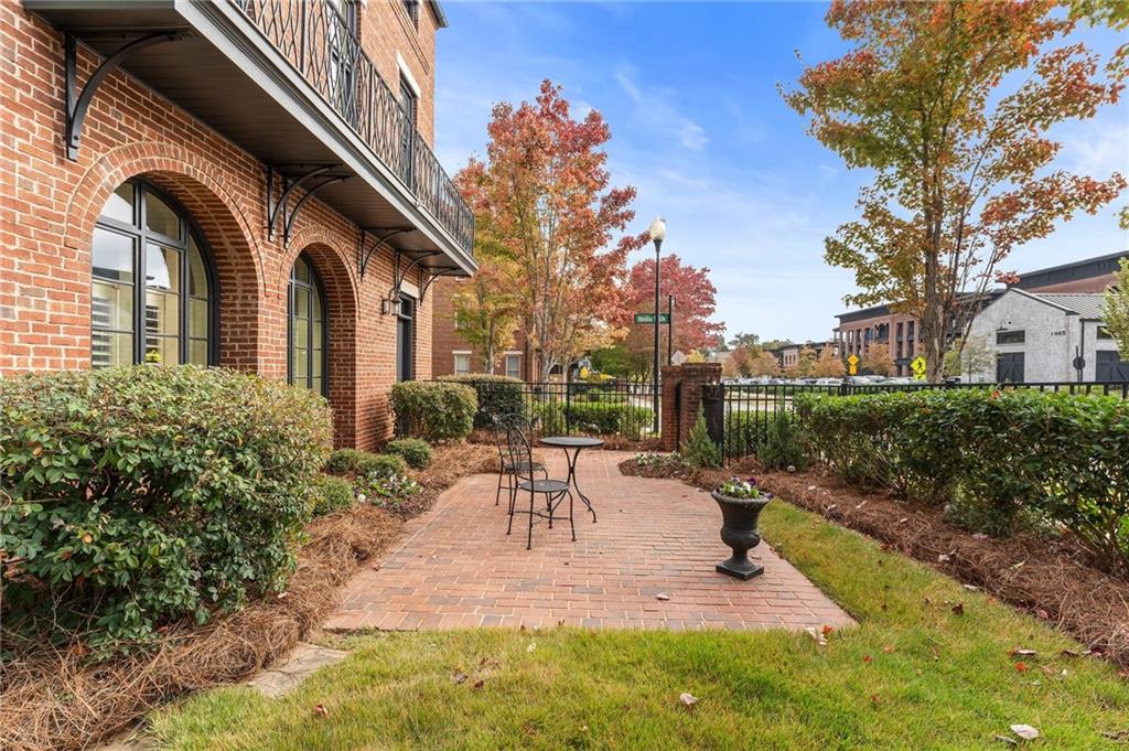 1950 Heritage Walk Alpharetta, GA 30004 - Photo 6 of 64 a view of a patio with table and chairs potted plants and large tree