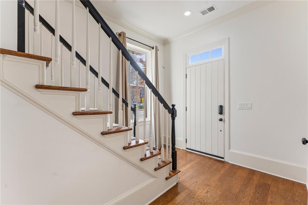 1950 Heritage Walk Alpharetta, GA 30004 - Photo 8 of 64 a view of staircase with wooden floor and white walls