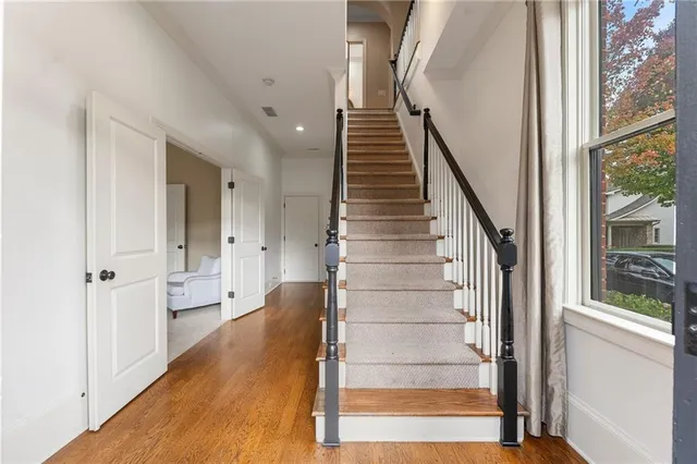 a spacious bedroom with a bed and a window