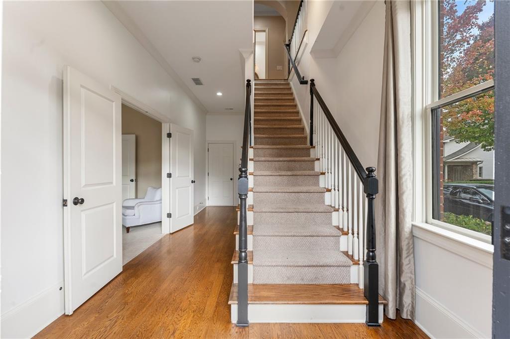 1950 Heritage Walk Alpharetta, GA 30004 - Photo 9 of 64 a view of an entryway with wooden floor and staircase