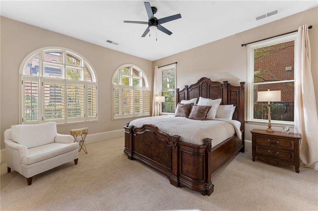 1950 Heritage Walk Alpharetta, GA 30004 - Photo 10 of 64 a spacious bedroom with a bed and a couch