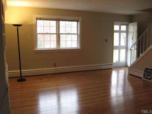 837 Bryan Street Raleigh, NC 27605 - Photo 6 of 11 Bright living room with half-bath beneath stairs...neutral colors for easy decorating! Other