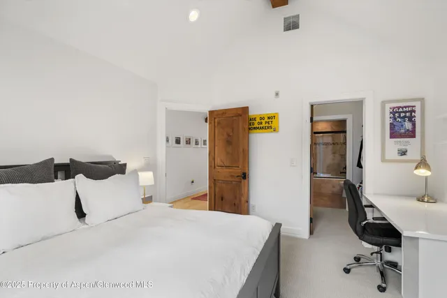 a bedroom with a bed and a desk