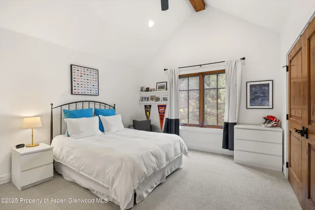 a bedroom with bed and window