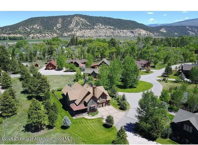 an aerial view of a house with yard and outdoor seating