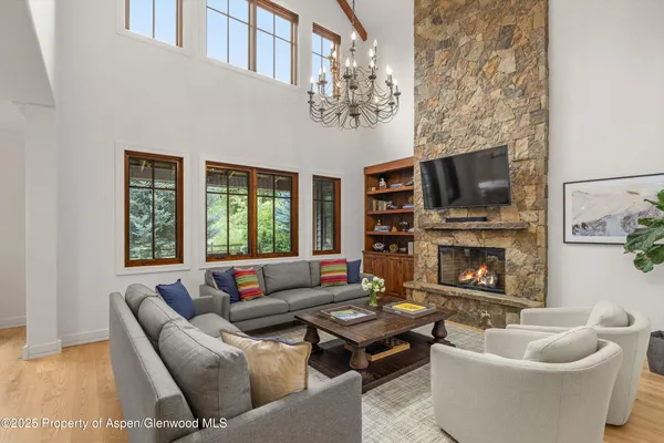 a living room with furniture a fireplace and a flat screen tv