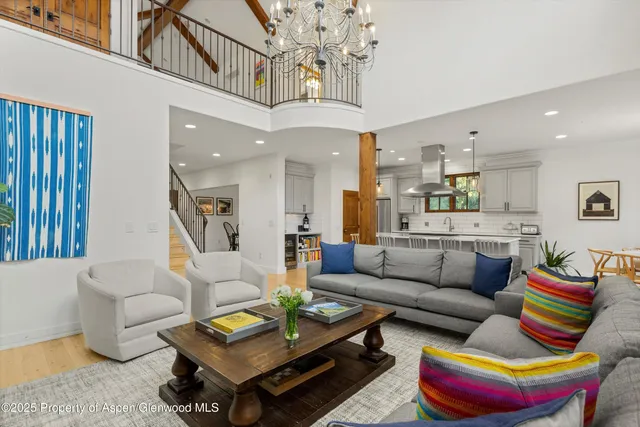 a living room with furniture and a chandelier