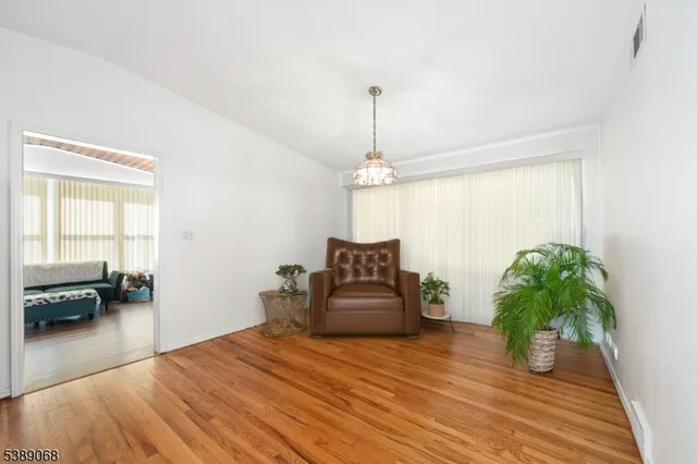 a bedroom with a bed and a potted plant